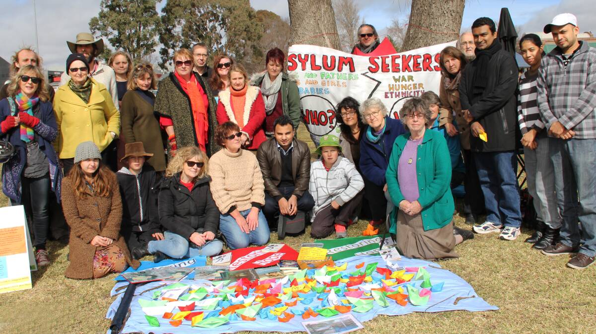 STAND UP: Armidale campaigners at the Palm Sunday protest made a flotilla of paper boats in solidarity for refugees and asylum seekers in 2014.