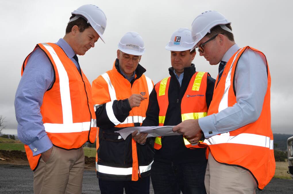 FRONT FOOT: NSW Environment Minister Mark Speakman, Goldwind Australia managing director John Titchen, Fulton Hogan project manager Matt Landers and Northern Tablelands MP Adam Marshall looking over plans on the White Rock wind farm.