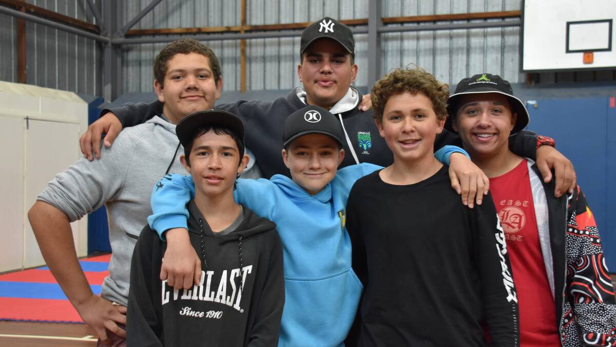 Packing a punch: Malakye, back centre, is one of the leaders in the Nanyupura boxing program in Armidale at the PCYC.
