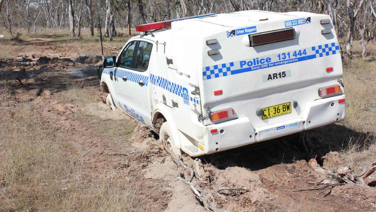 Stuck in the mud: An excavator had to be called in to remove two vehicles which got bogged in Armidale on Tuesday morning. Photos: Breanna Chillingworth
