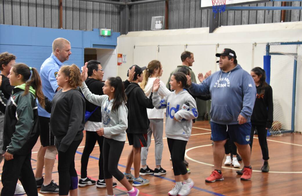 Packing a punch: The boxing sessions can attract more than 80 participants, top, and aims to build self-discipline, respect and recognition for local kids.