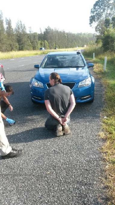 Under arrest: Daniel Gallaher is handcuffed by Armidale detectives on the side of the road in 2015. He told an undercover officer he was "the boss".