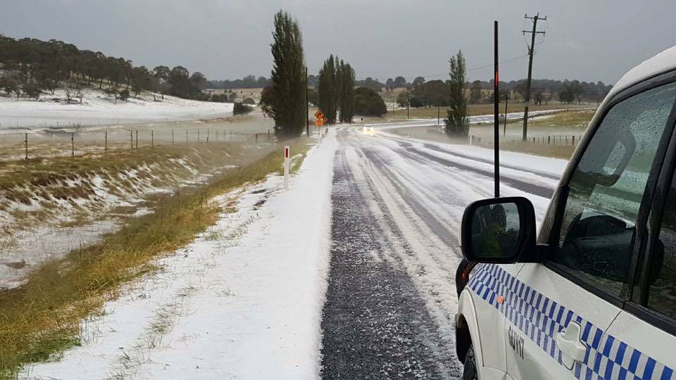 White Christmas: Hail up to the ankles of emergency services fell on the New England Highway near Guyra. Photo: New England Police