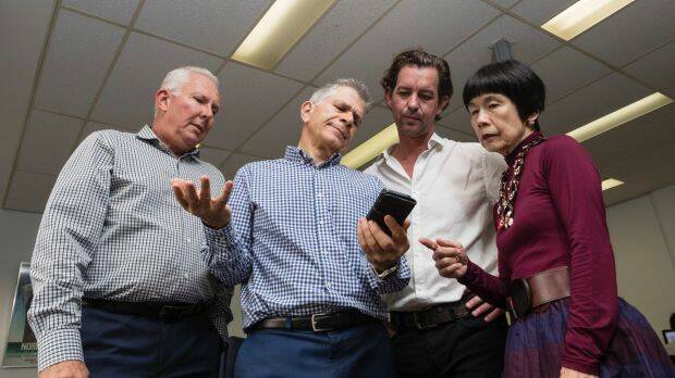Darren Williams, Peter Lynch, Dean Farrow and Teresa Ooi at Big Splash Media are among six members of staff using one phone and without the internet due to delays in getting connected to the NBN. Photo: Brook_Mitchell