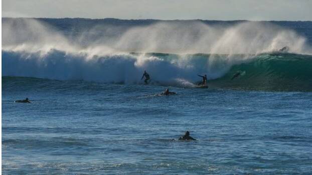 Surfers take to the water mid-winter at Golf Course Reef, Mollymook. Photo: Karleen Minney