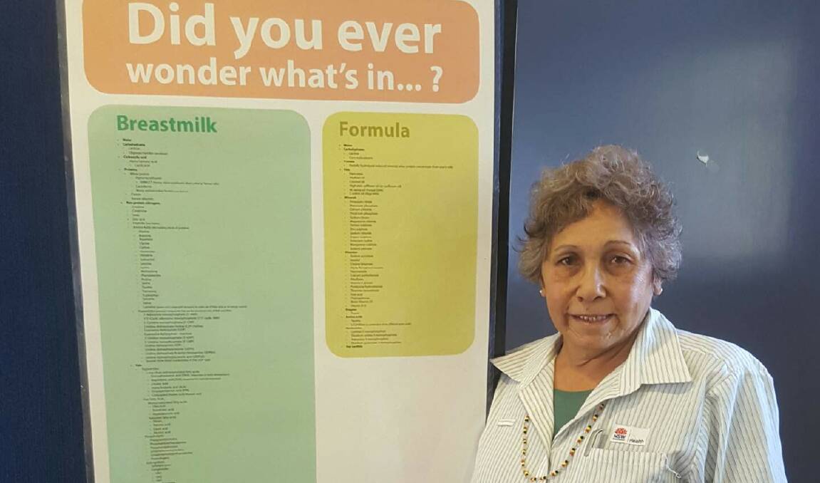 Aunty Mary Munro, a community elder, Karrali Aboriginal health worker and breastfeeding mentor with a poster detailing what is in breast milk.