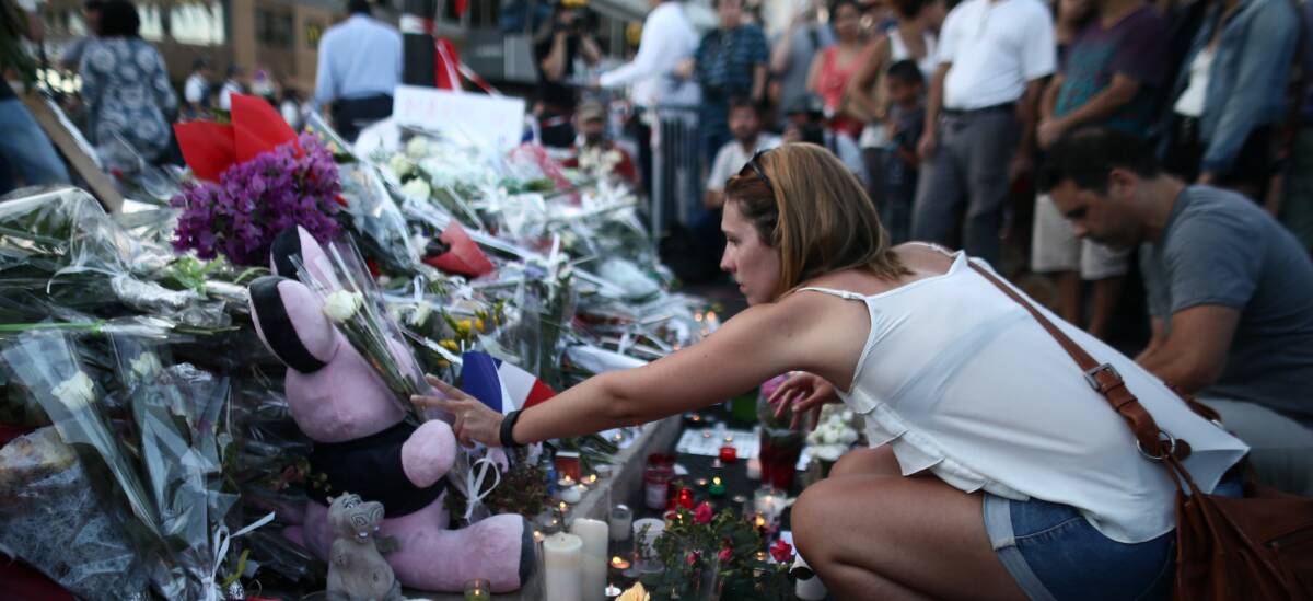 TRIBUTE: People gather and lay tributes on the Promenade des Anglais on July 15, 2016 in Nice, France.