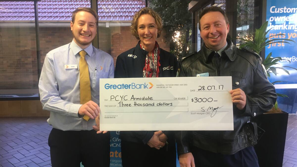 Greater Bank Customer Service Officer, Connor McGregor (left), handing over the cheque to PCYC Armidale, Michelle Rottcher, and Senior Constable Darren Griggs.