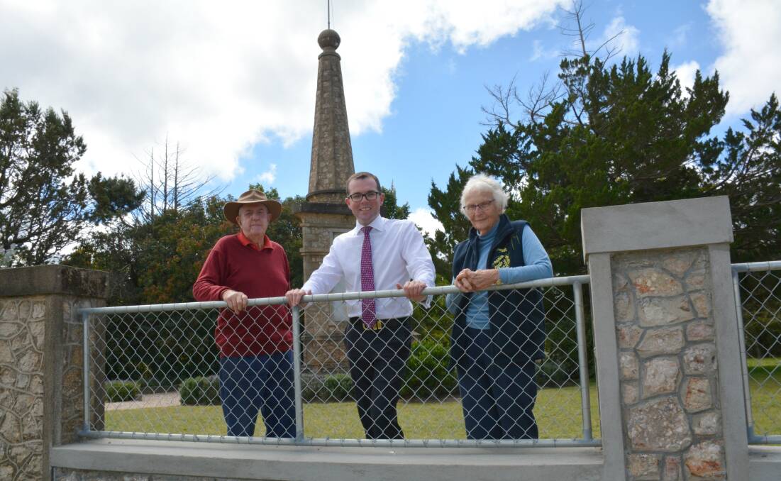 Armidale Historical Society members Peter Elliott and Judith Grieve get a close look at the new section of fencing at the Dangarsleigh War Memorial with Northern Tablelands MP Adam Marshall.
