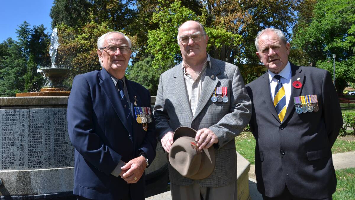 Ken Dickins (centre) at the memorial fountain during a recent Remembrance Day service with Bob Holloway and Max Tavener.