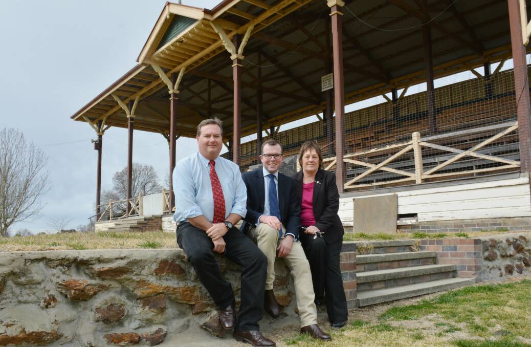 NSW Crown Lands Manager Rodney O’Brien, left, Northern Tablelands MP Adam Marshall and Armidale Showground Reserve Trust Chairperson June Dangar take a seat in front of Armidale Showground’s Eastern Grandstand.