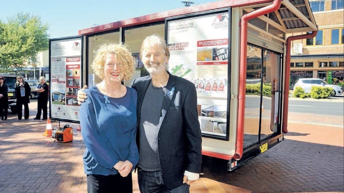 Kathryn Heiler and John Jarratt in front of the asbestos ADRI house, which travels Australia raising awareness of asbestos in homes.