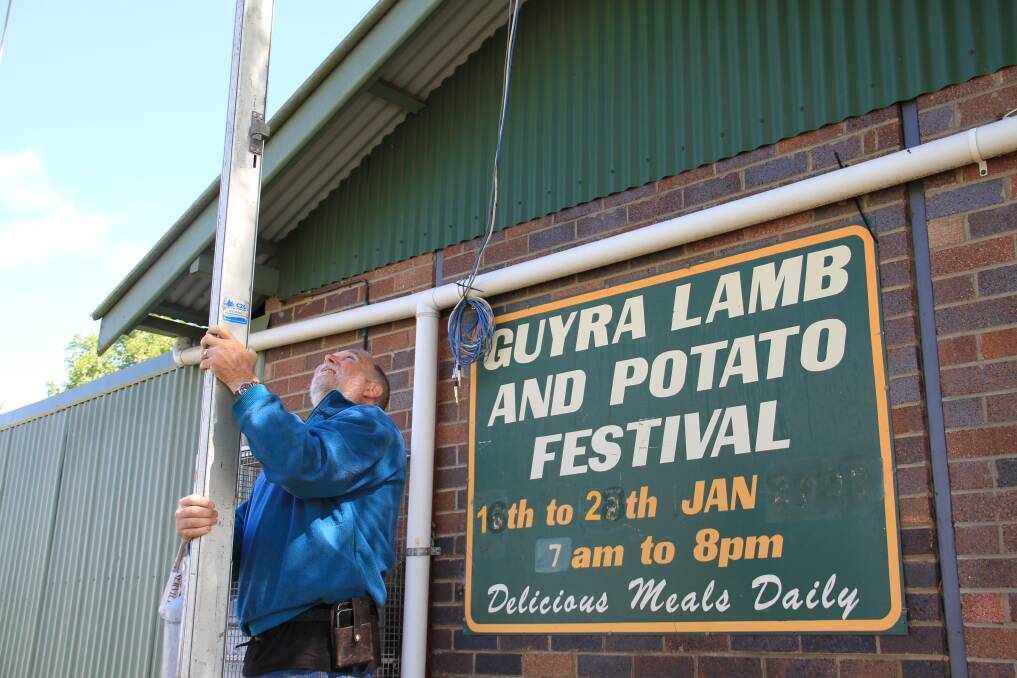 Guyra Lamb and Potato Festival Committee President Steve Mepham helps to erect a gazebo on the festival grounds.