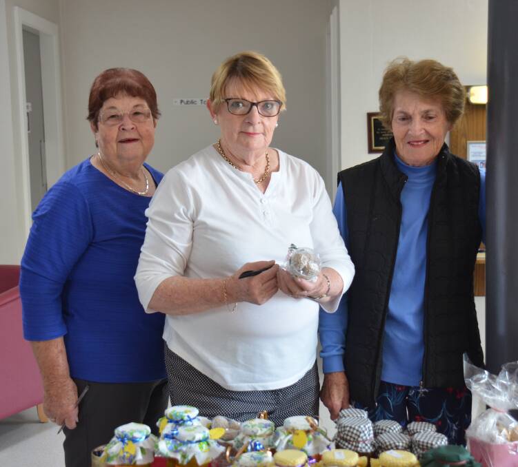 A HELPING HAND: Armidale Hospital Auxiliary's Sandy Mckay, Sue Melville and Robyn Clutterbuck at their last bake sale for the year on Tuesday morning. Photo: Rachel Baxter.