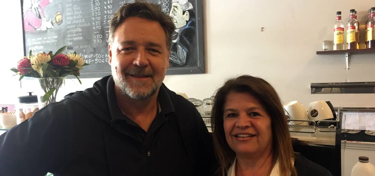 Star struck: Super star Russell Crowe stops in for a photo with coffee shop co-owner Chrissy Rologas at the Courthouse Coffee shop in Armidale on Monday.