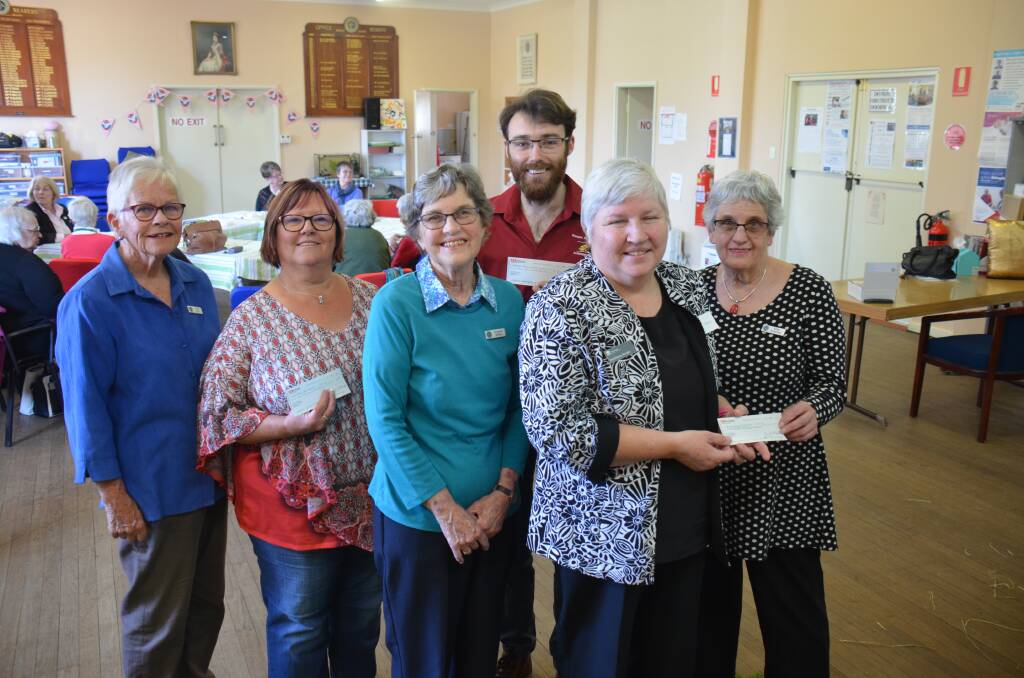 GIVING GENEROUSLY: Armidale Country Women's Association members with proud cheque recipients at the CWA rooms on Thursday afternoon. Photo: Rachel Baxter.