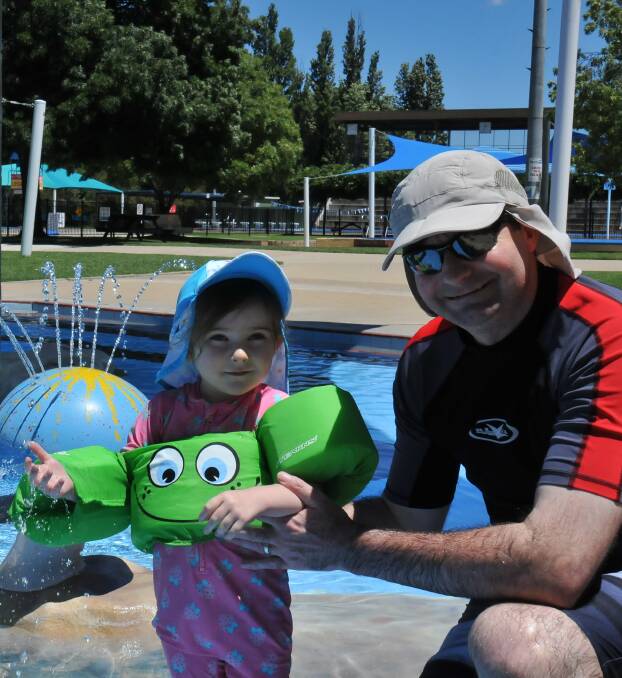 MELTING POINT: Dominic and two-year-old Mena Worthington have been frequenting the local pool since summer hit and won't be far from the water's edge this weekend as temperatures hover just under 40 degrees.