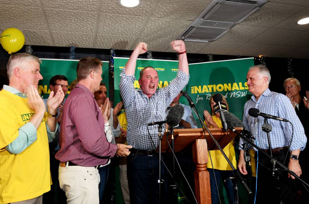 BIG WIN: Deputy Prime Minister Barnaby Joyce celebrates his New England win, flanked by supporters and Prime Minister Malcolm Turnbull. Photo: Gareth Gardner