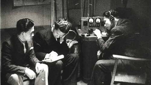 Tense wait: A scene from the 1946 Joris Ivens film Indonesia Calling showing Indonesian seamen in Sydney listening to a short-wave radio for news of Indonesia’s declaration of independence.