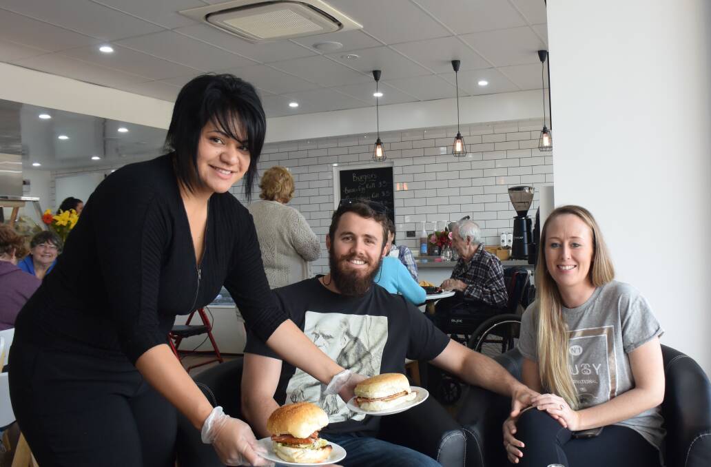 The Guyra Cafe's Chef Amanda Bishop serves a mouth-watering meal to locals Brett Nielsen and Celia Quinn.