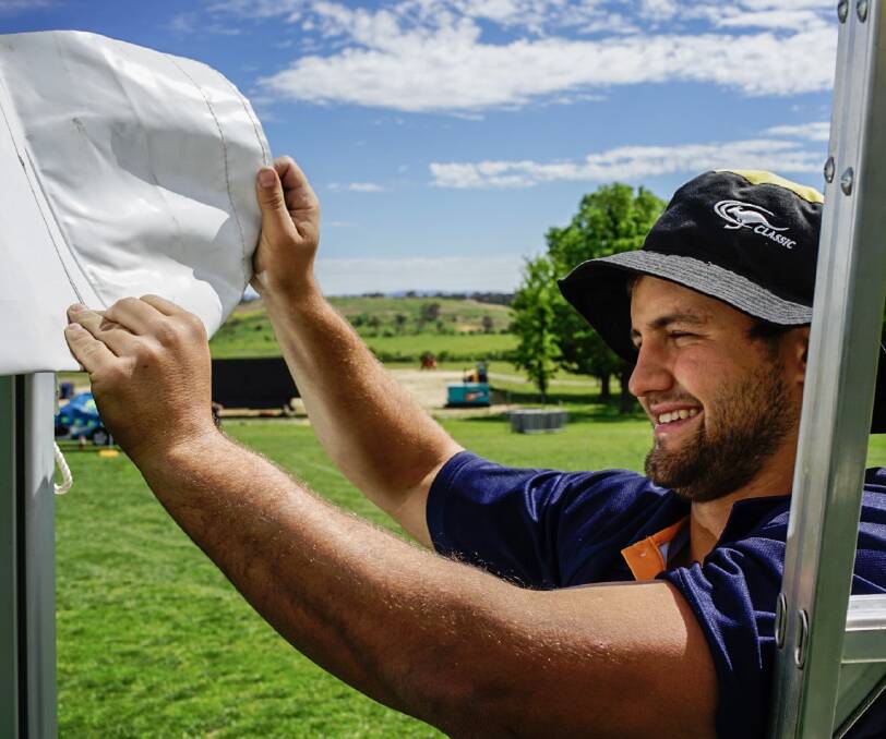 READY TO GO: Jonathan Green secures a tent at Petersons Winery for A Day on the Green in Armidale this weekend. Gates open 3pm.  See the Express extra for full details.