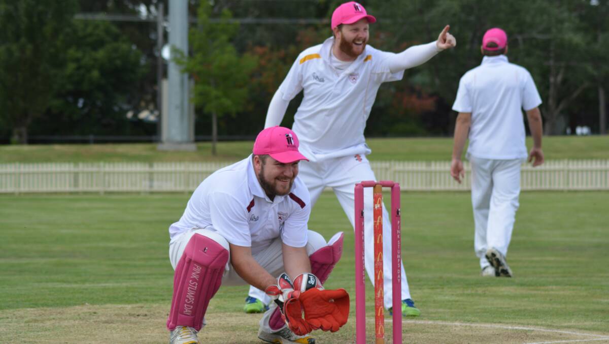TICKLED PINK: Paul Woodford and Stephen Butler celebrate a wicket on Pink Stumps day two years ago. The annual day is back this Saturday. 
