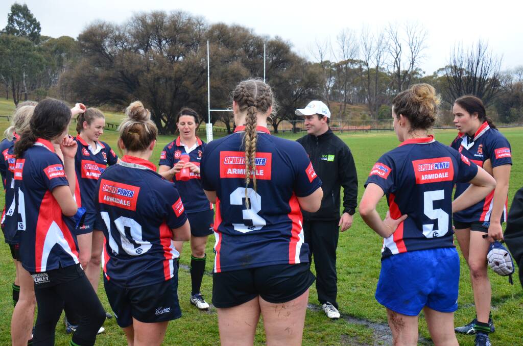 BRING INTO ACTION: UNE Lions coach Tom Bower addresses the side after a trial game against University of Queensland. 