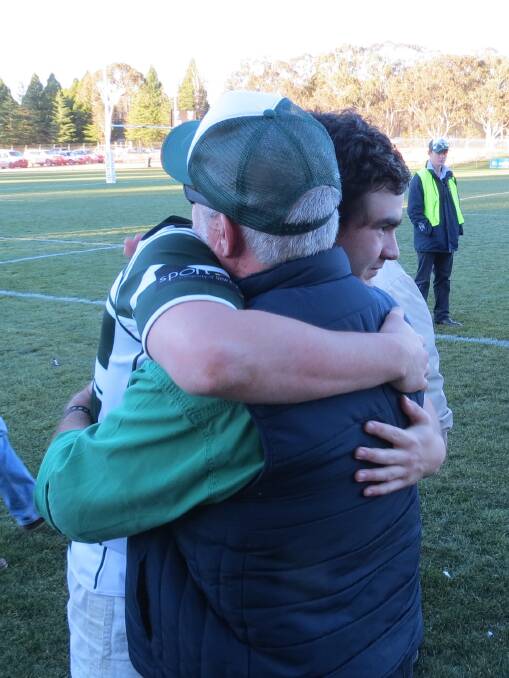 FAMILY TIES: Max and Steve Cowley embrace after the grand final clash. Photo: Jen Cowley. 