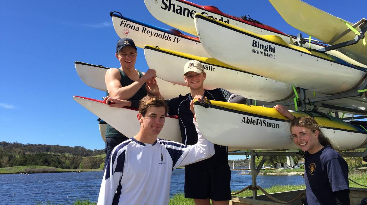 Sebastian Scott, Liam Donaldson, James Murphy and Georgie O’Brien load boats for the 50-strong TAS team in this weekend’s Hawkesbury Canoe Classic.