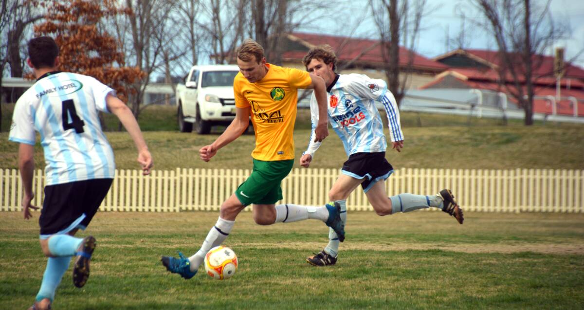 ON THE RUN: South Armidale's Jamie Wright beats Tamworth FC's Travis Beard to the ball in Saturday's semi-final. Souths knocked FC out of the competition with a 1-0 win. 