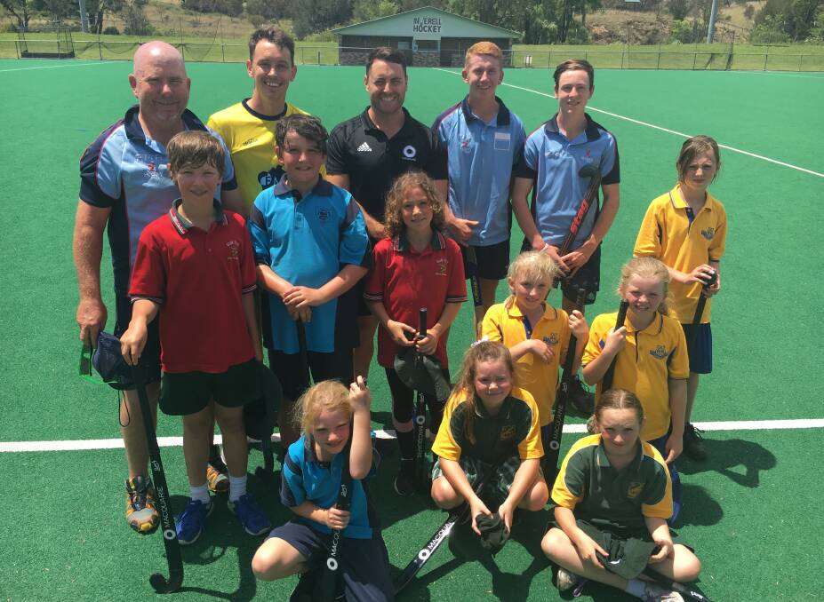 Expertise: Talented Armidale juniors Darby Chalmers (back second from right) and Nathan Czinner (back right) were spreading the hockey message in Inverell and Moree last week. Photo: Heidi Gibson