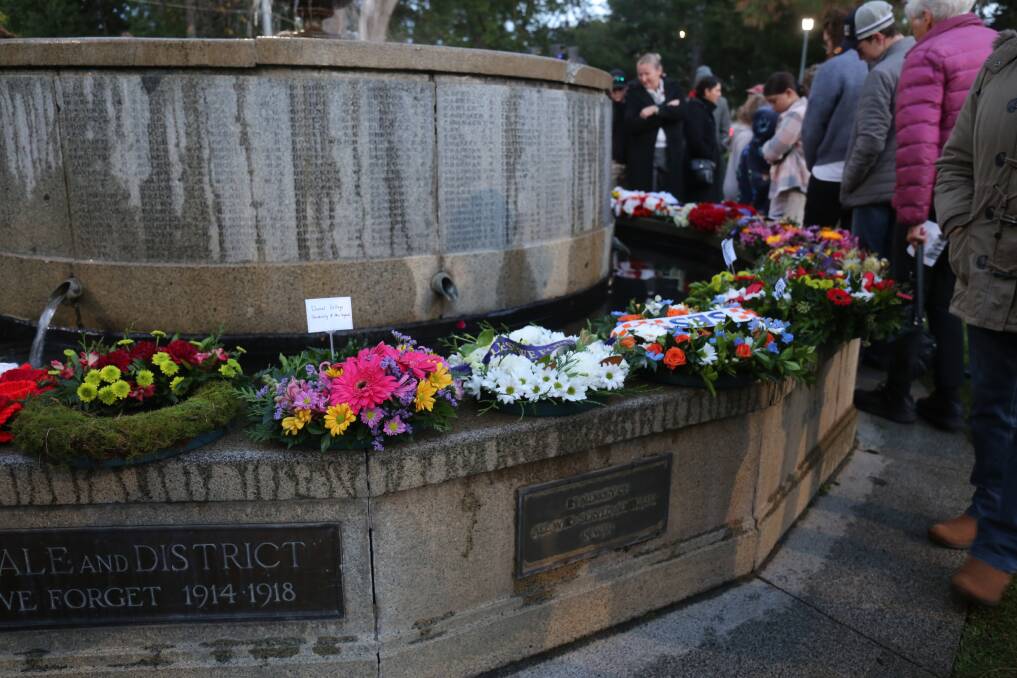 Service goers pay their respects at the Central Park War Memorial where around 20 wreaths were laid at the Anzac Day dawn service. 