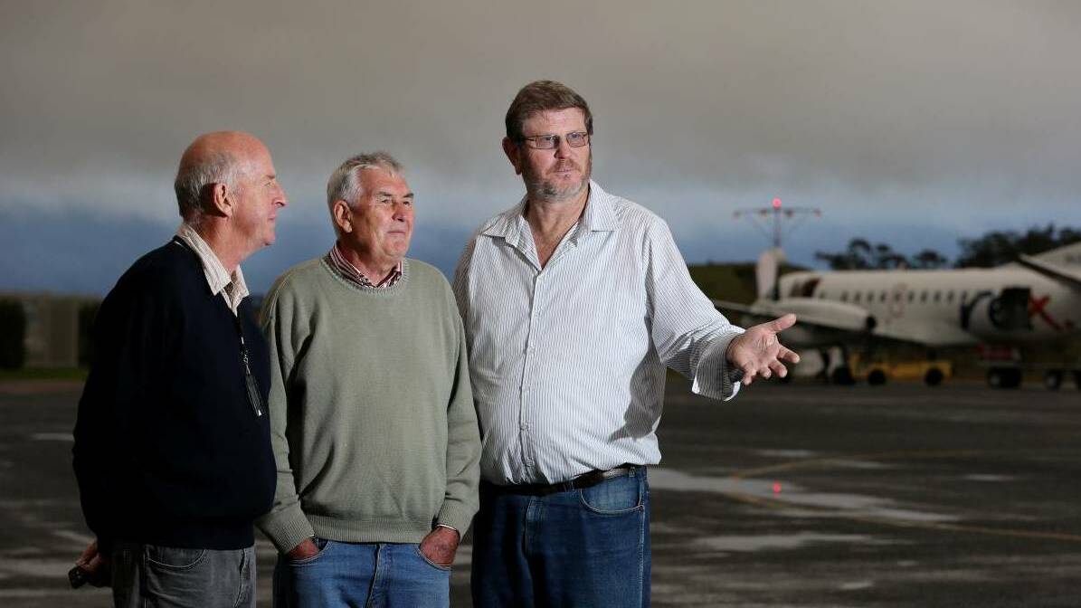 AIRPORT UPGRADE: Armidale Regional Airport users group Don Tydd, Edwards Aviation owner Brad Edwards and Armidale Regional councillor Andrew Murat inspect the airport in 2014. Photo: Matt Bedford
