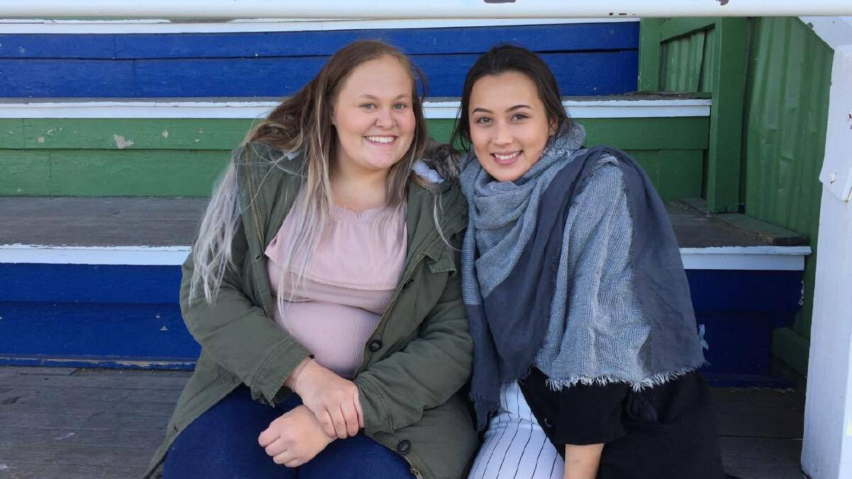 WATCHING ON: Jaida Stevens and Emma Armstrong enjoying the rugby game.