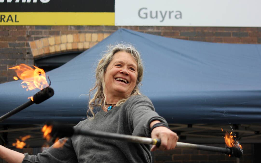 FUN WITH FIRE: Fire twirler Mari Grantun performed her dangerous stunts for crowds at the Guyra Trout Fest Market Day on Saturday.