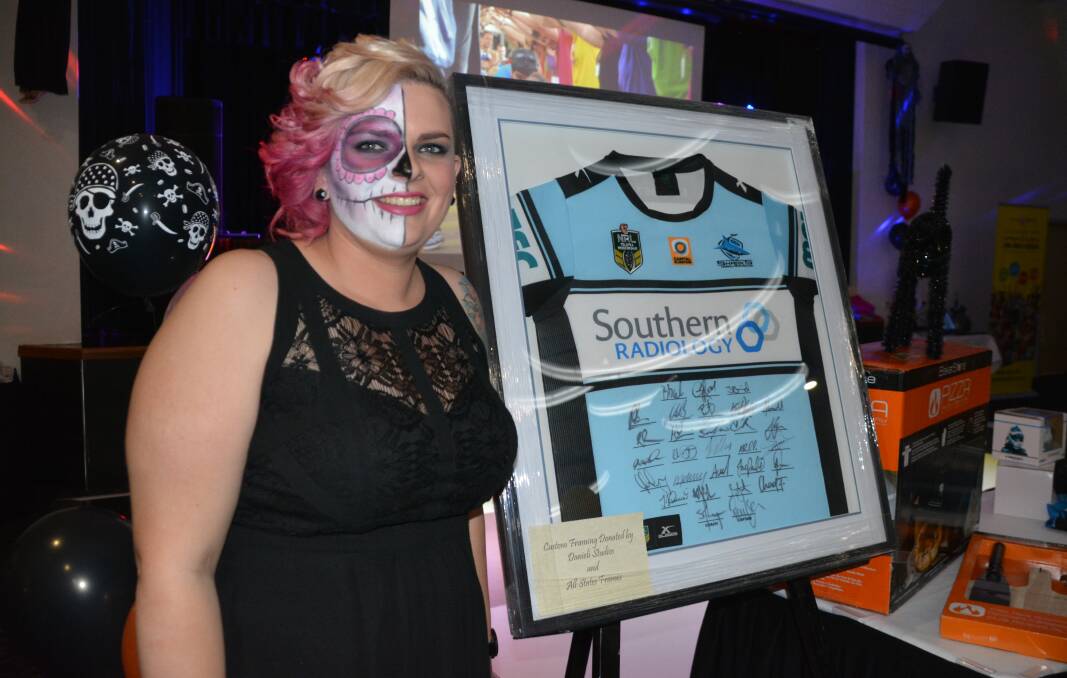 Bailie Rolff with the Sharks jersey auctioned at the ball.