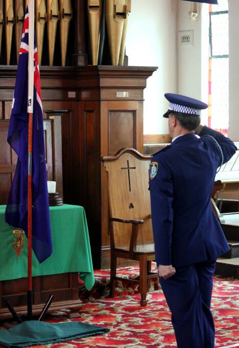 Senior Constable Coulter salutes the Australian flag and pays his respects at the service. National Police Rememberance Day is held on September 29.