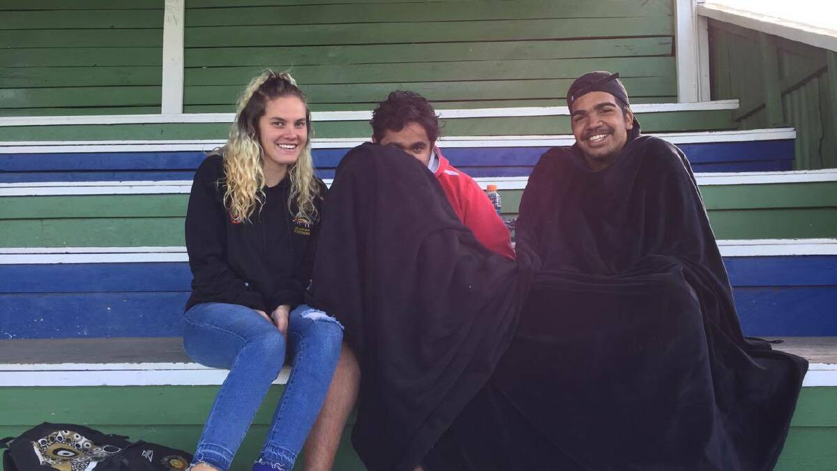 RUGGED UP: Shaynia Duncan, Jarryd Ritchie and Wade Graham all had the right idea on Saturday with a warm blanket.