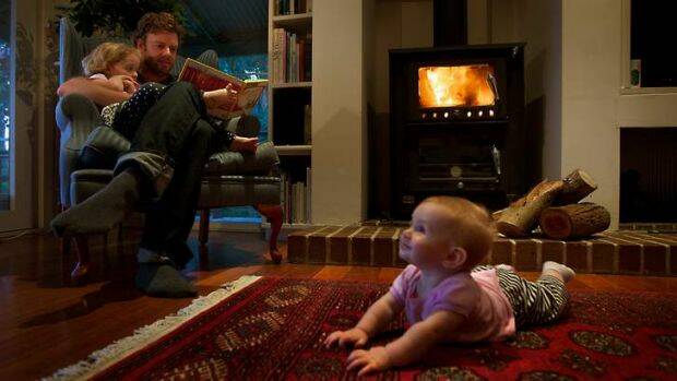 FIRE HAZARD: A family in front of a wood fire heater. Photo: Simon O'Dwyer.