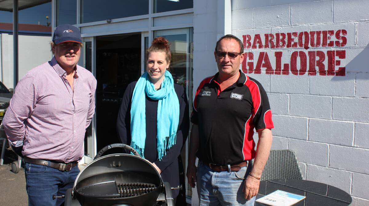 James Barnier, Kate Reed and John Grills at Barbeques Galore. Mrs Reed has won a Zeigler and Brown barbecue from the store as part of a REX Airlines promotion.