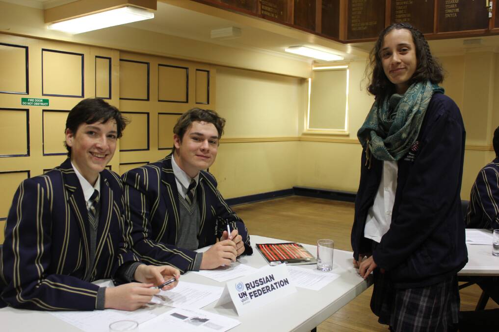 PROBLEM SOLVING: The Armidale School students Yannick Turnsan D'espaignet and Will Almond in discussions with Armidale High student Ella Pringle.