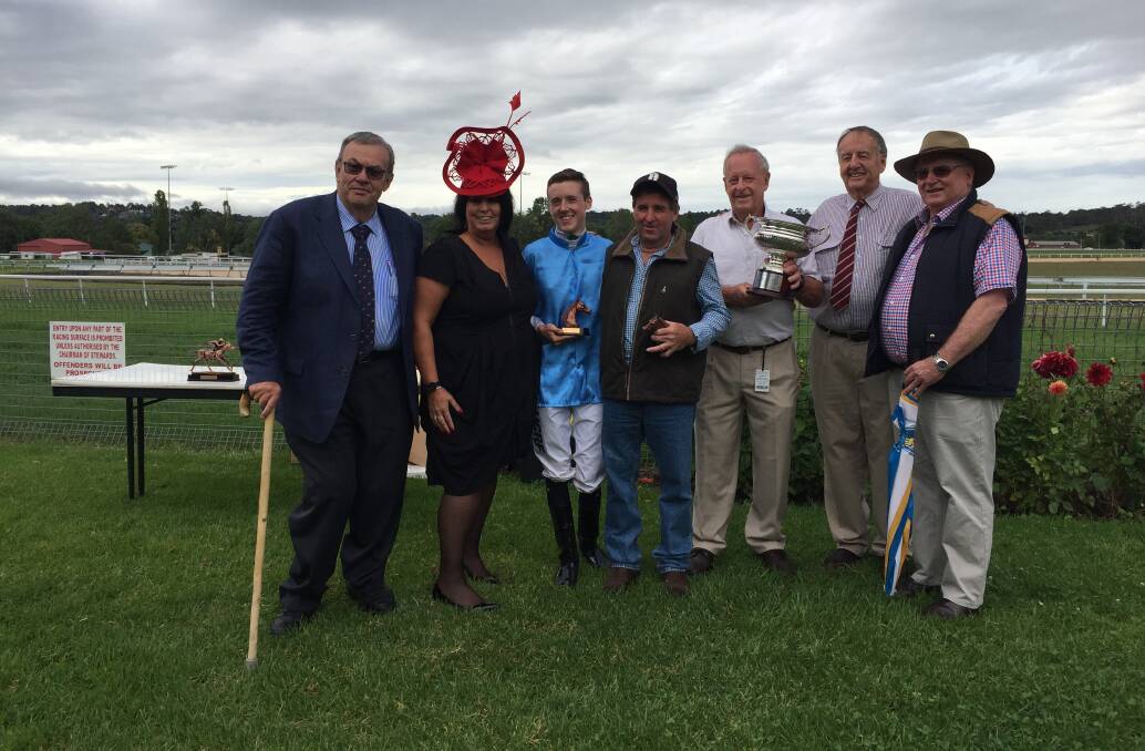 Feature win: Jockey Jackson Murphy and trainer Paddy Cunningham pose with officials after winning Monday's Armidale Cup thanks to Carry Me Jake. 