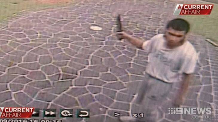 Footage shows Ihsas Khan outside the hair salon with knife in hand.  Photo: Channel 9/A Current Affair