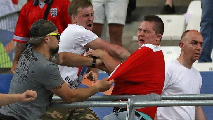 Russian supporters attack an England fan at the end of the Euro 2016 group match between England and Russia, at the Velodrome stadium in Marseille, France.