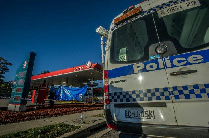 NSW police officers and SES personnel attend the scene of a fatal stabbing at the Queanbeyan Caltex service station. Photo by Karleen Minney. Photo: Karleen Minney