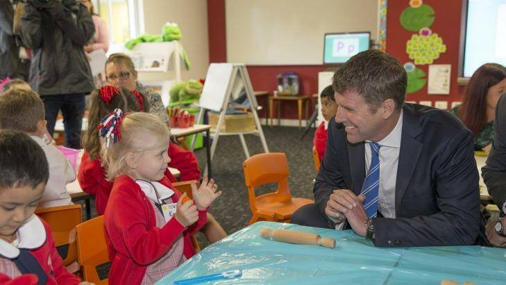First termers: Premier Mike Baird meets kindergarten student Kassie at the opening day of the Ponds High and Riverbank Public schools. Photo: Geoff Jones