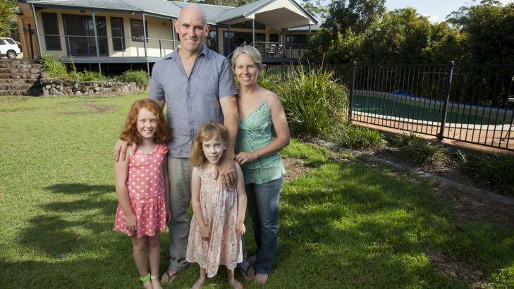 Belinda Kerr at home on Queensland's sunshine coast with husband Michael Trehy and daughters Molly, left, and Ivy. Photo: Glenn Hunt