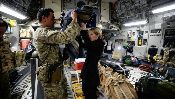 Foreign Affairs Minister Julie Bishop visits the Troops at KAIA-N base in Afghanistan. Bishop is helped into her body armour on the RAAF flight to Kabul. Photo: Justin McManus