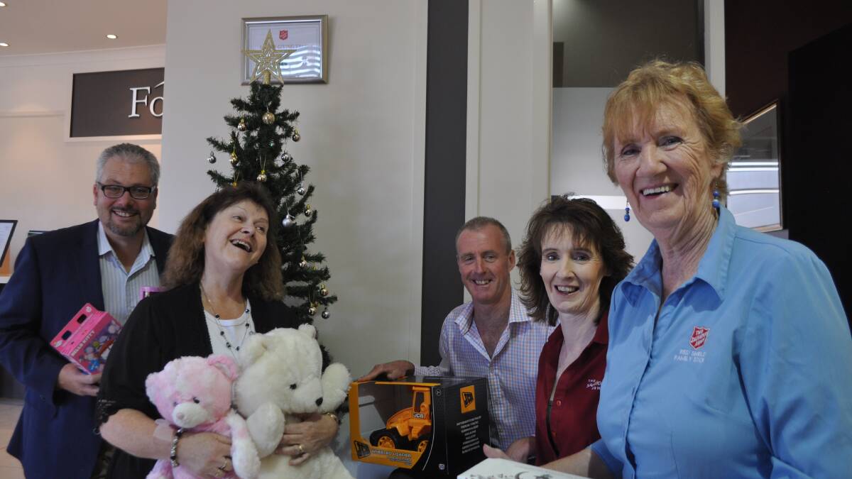 CHARITY: Paul Cornall, Fay Weiss and Andrew Kirk from Forsyths with presents they’ve donated and volunteers Noeline Corcoran and Isabel Butler.