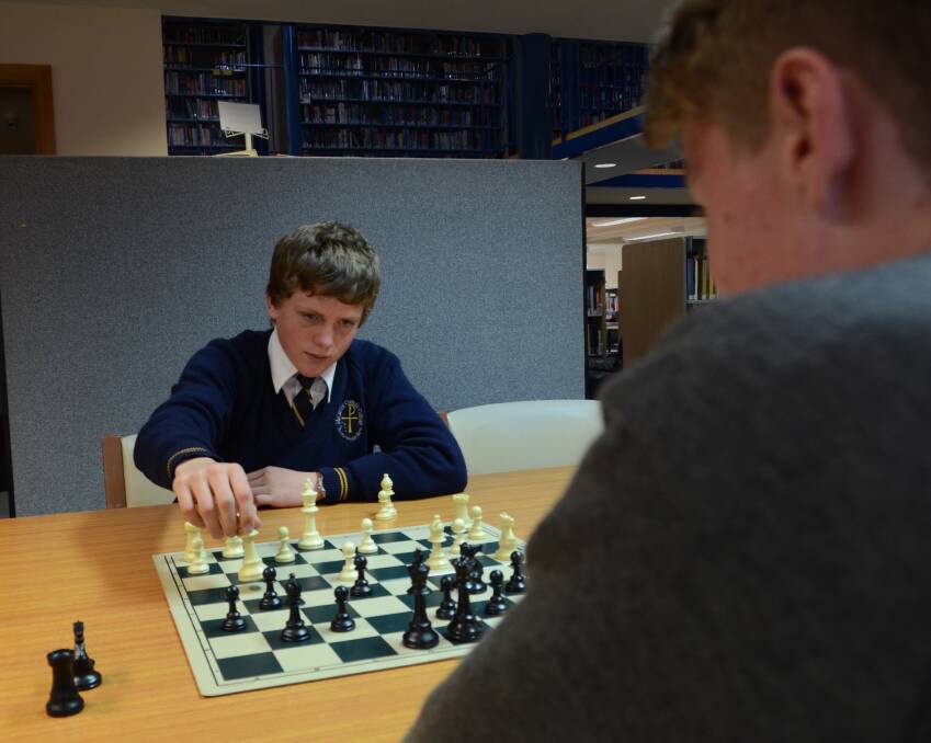 BATTLE PLAN: Jack Hannaford from McCarthy Catholic College moves his queen in a game against Josh Stevenson from The Armidale School.